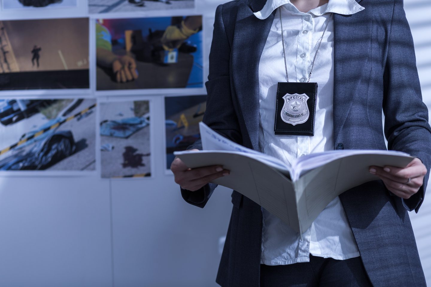 Police officer reviewing files and documents at a desk
